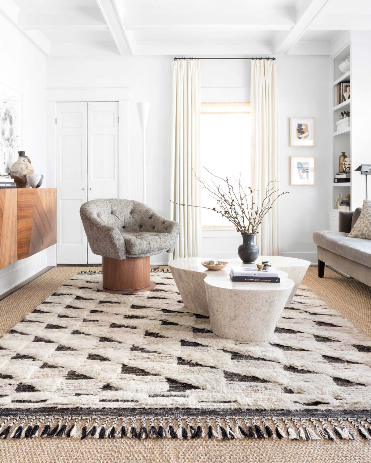 Hand-knotted rug with natural and black abstract stripe pattern and fringed edge