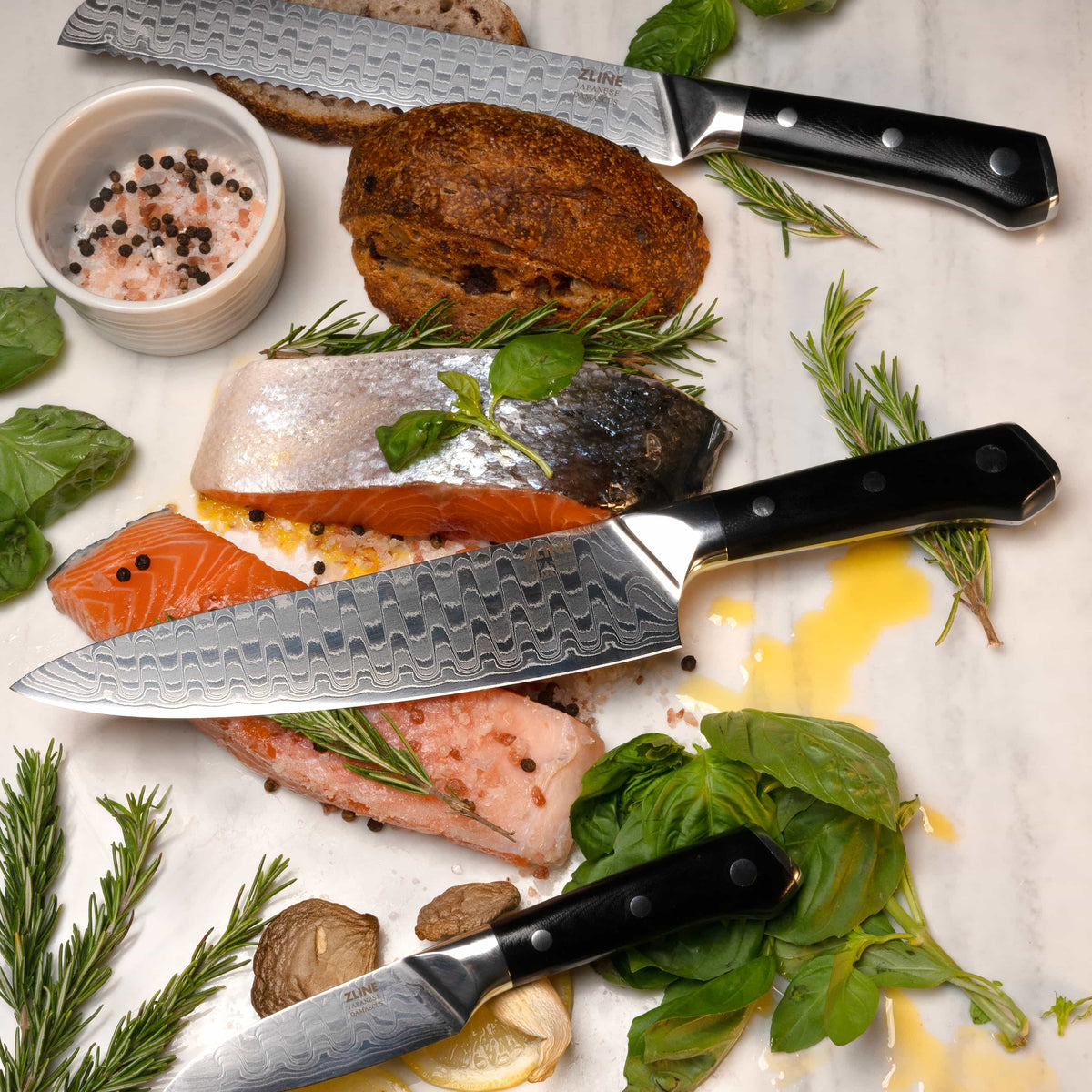 Three-piece knife set with Damascus blades and black handles with white dot rivets