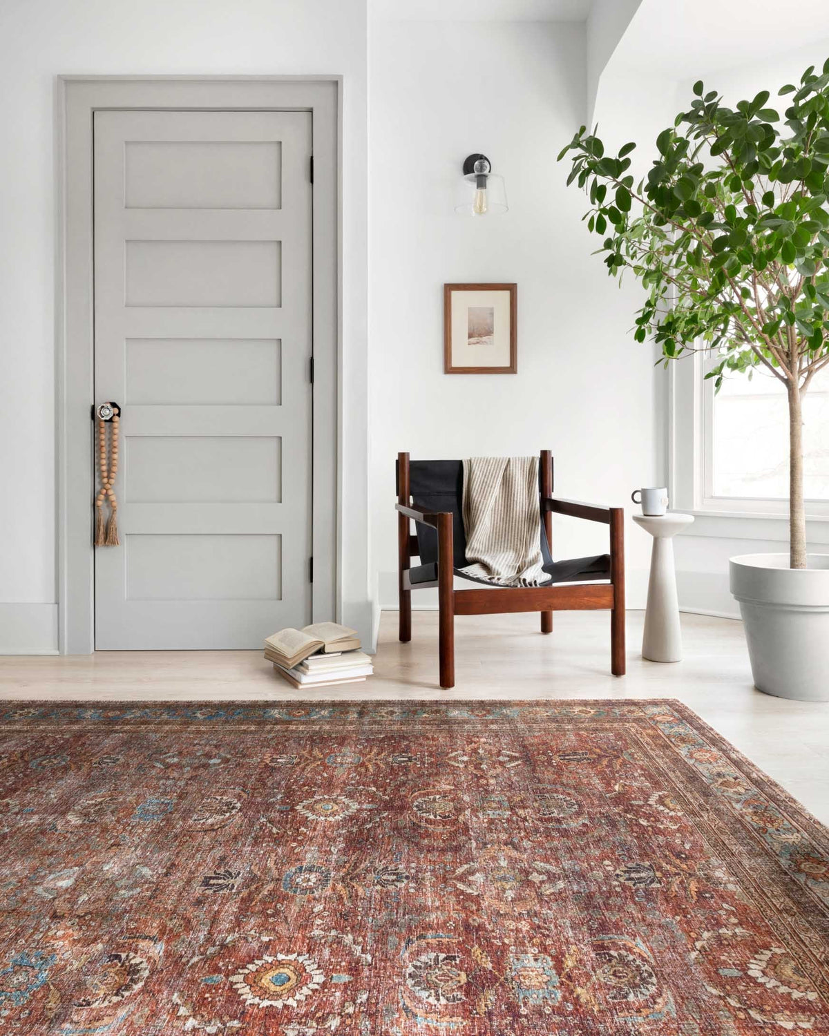 Brick and blue traditional area rug on the floor in a living room setting.
