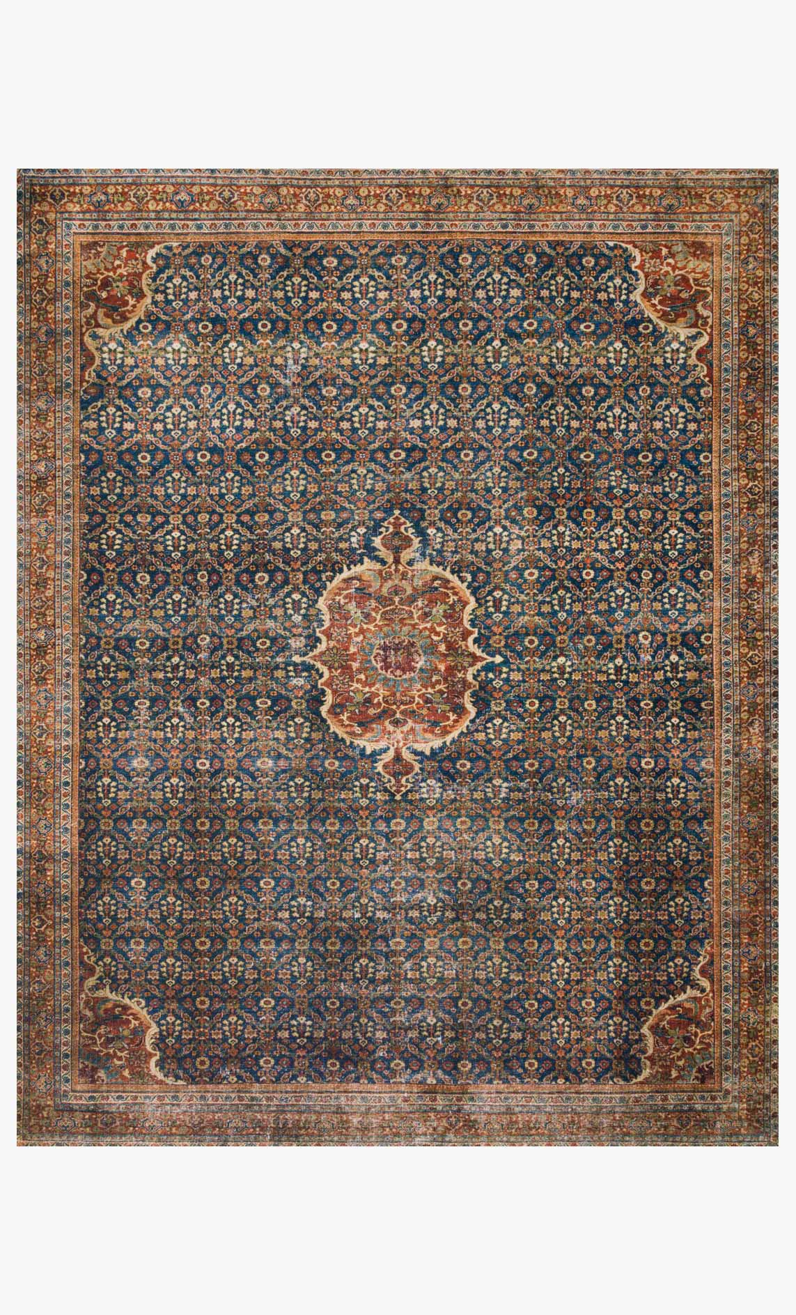 Traditional power-loom rug with cobalt blue field, medallion motifs, and spice accents.