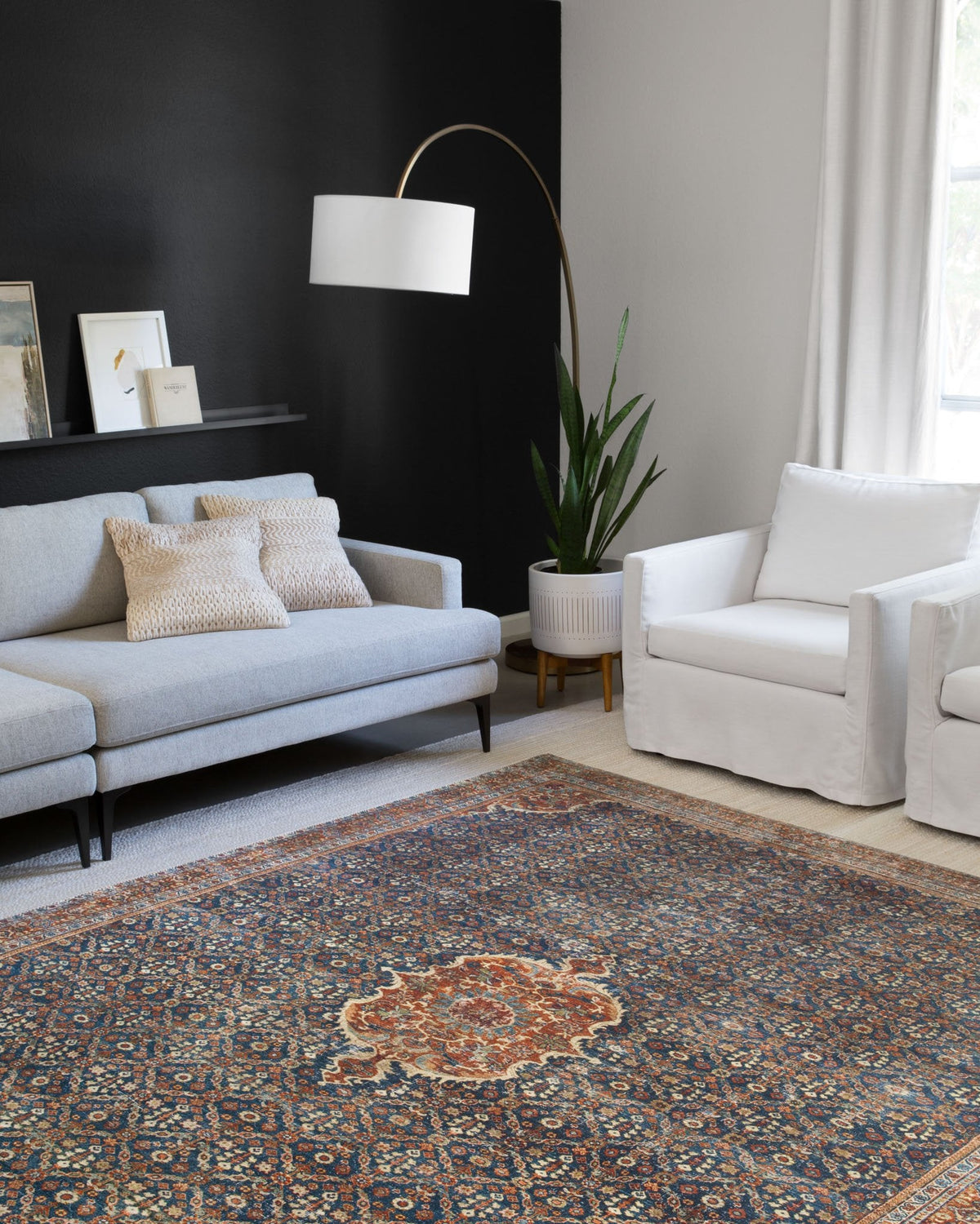 Cobalt blue traditional rug with ornate medallion center and spice red/orange details.