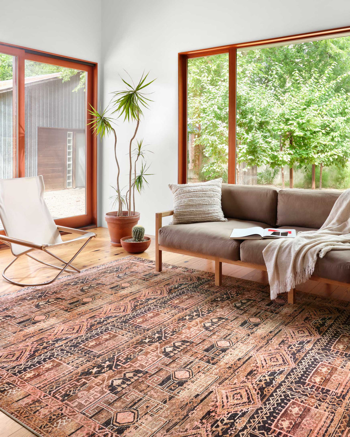 Mocha and blush traditional power-loomed rug with geometric motifs in a distressed look.