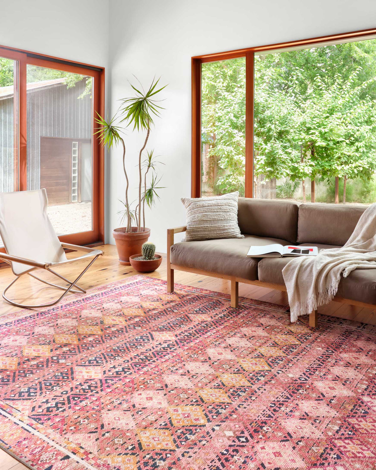 Magenta and cream geometric traditional rug with medallion motif on floor