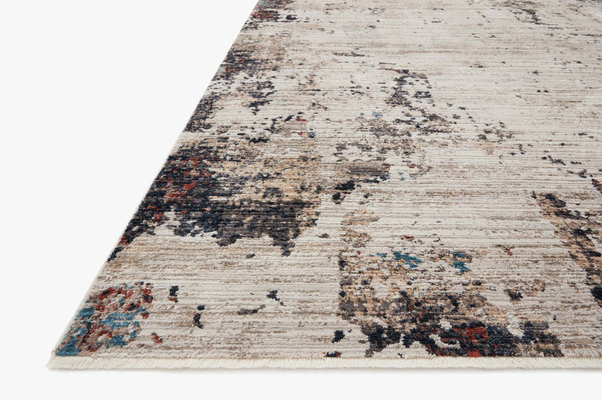 Ivory and charcoal power-loomed rug with distressed abstract pattern, angled view.