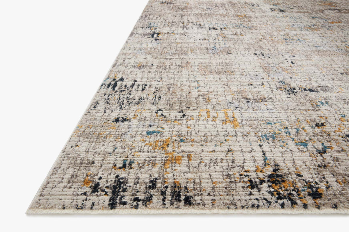 Corner view of ivory and granite power-loomed rug with distressed abstract design.