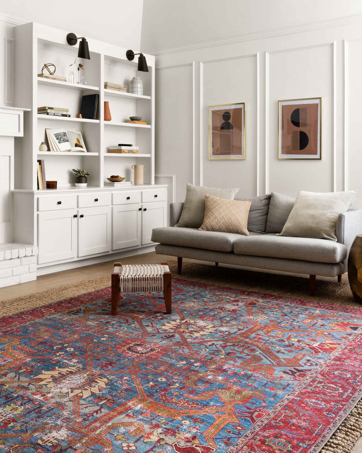 Blue and red traditional rug with ornate geometric motifs, shown in a living room setting.