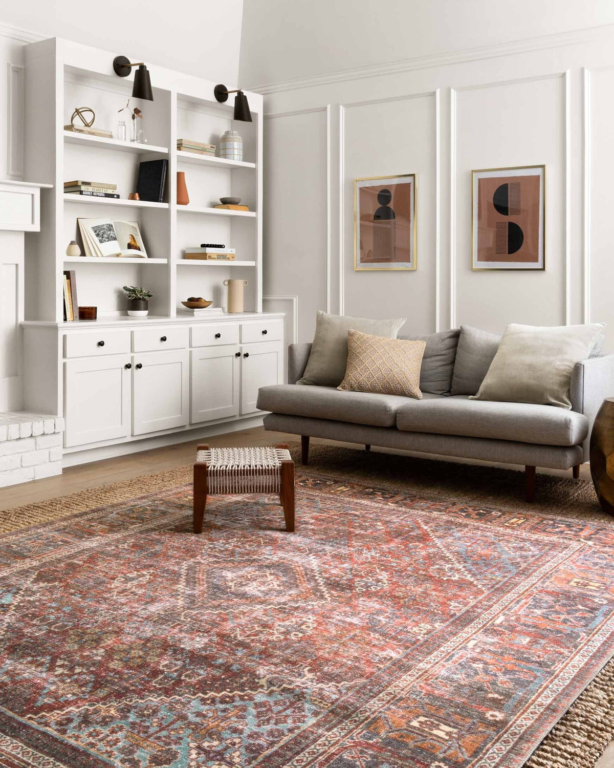 Brick-and-midnight patterned rug in living room, floral medallion center.
