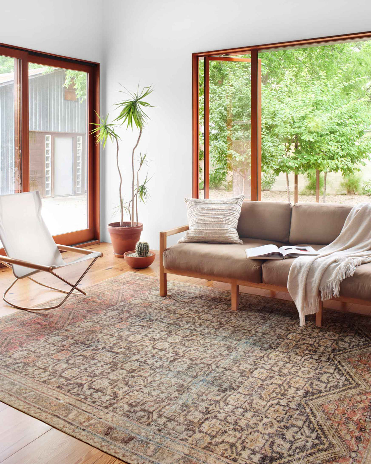 Traditional patterned area rug in charcoal gray with rust and beige accents