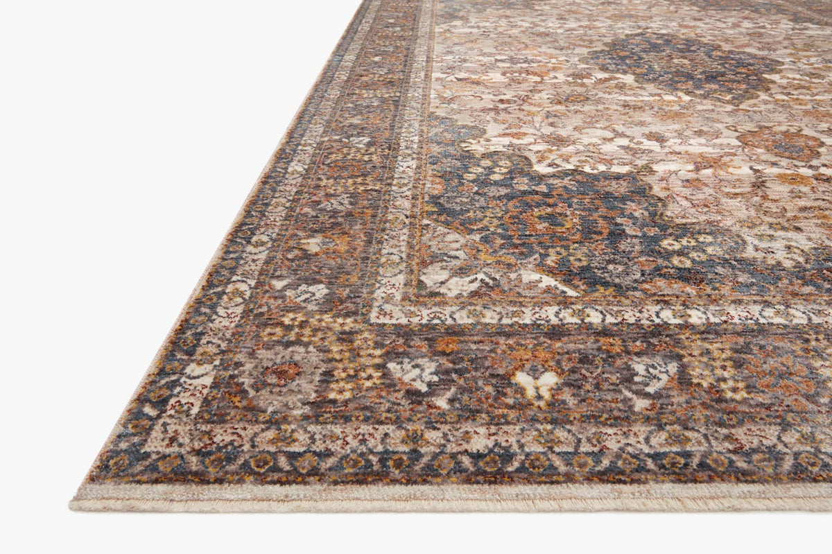 Corner view of traditional rug with border medallion in beige and blue tones