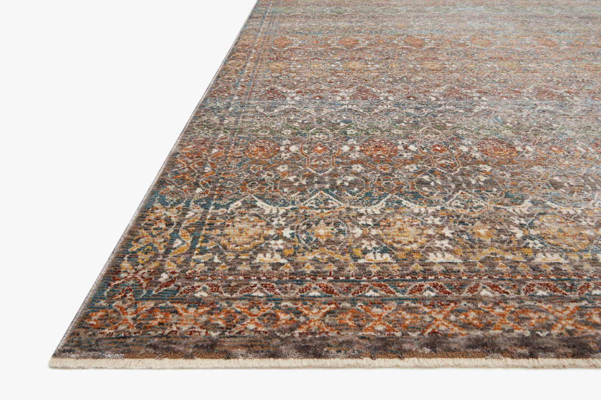 Corner view of traditional multicolor rug with geometric motif and stone-gray background