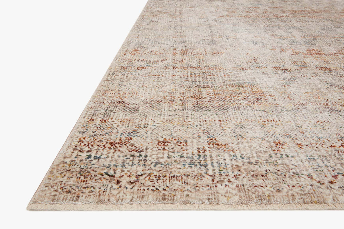 Ivory and spice rug with distressed abstract pattern, visible corner and angled edge