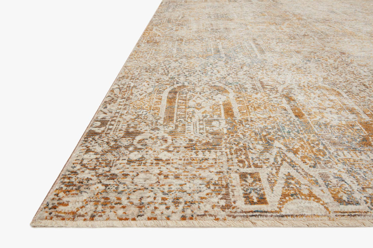 Power-loomed rug corner in ivory and orange geometric motifs, distressed texture