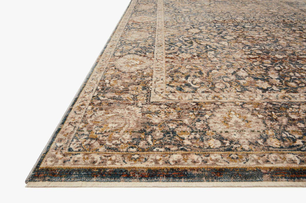 Traditional power-loomed rug corner with distressed motifs and charcoal/ivory border