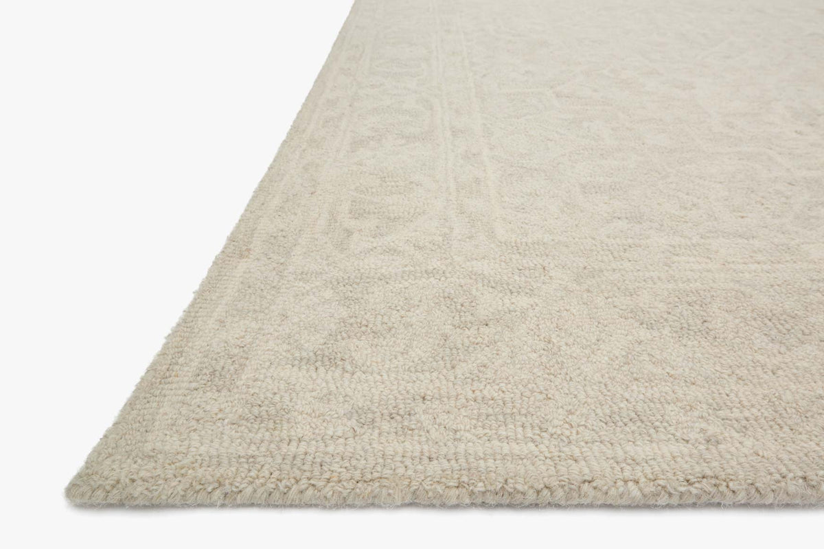 Bone rug corner close-up with hooked texture and low-pile pattern