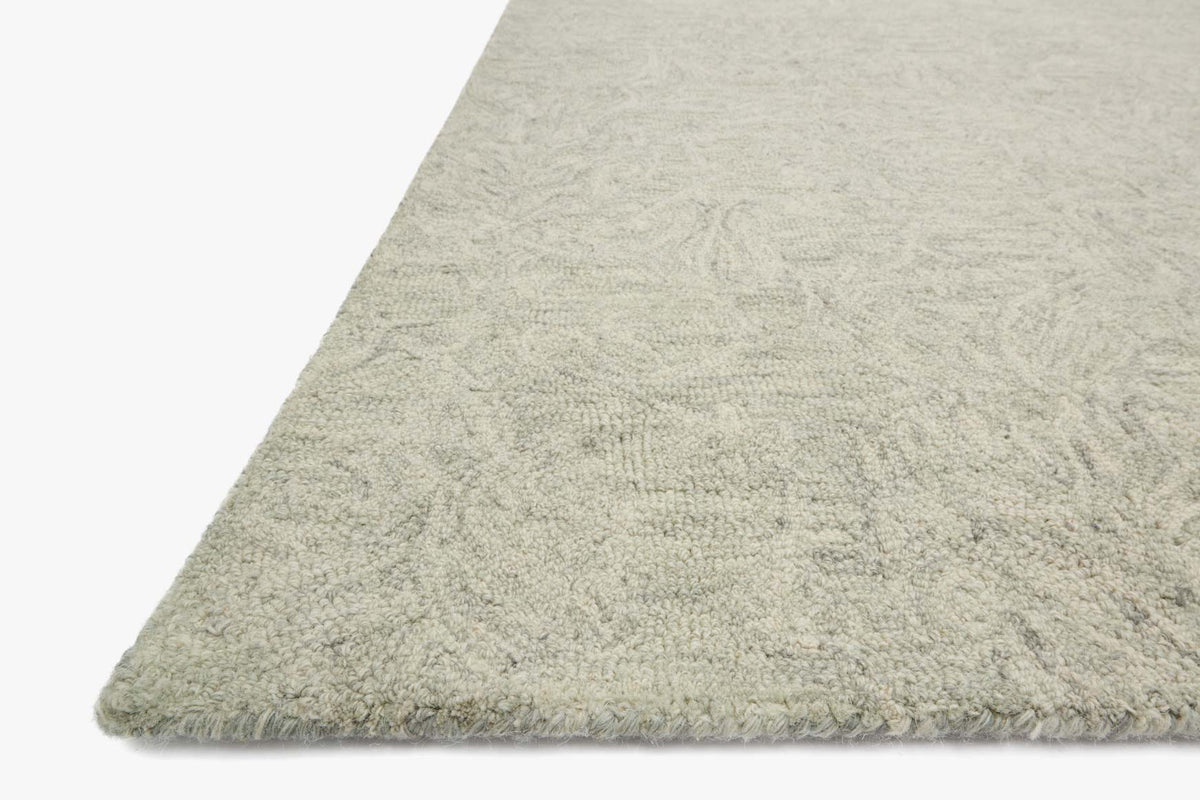Light mist hooked rug corner with textured short pile and trimmed edge