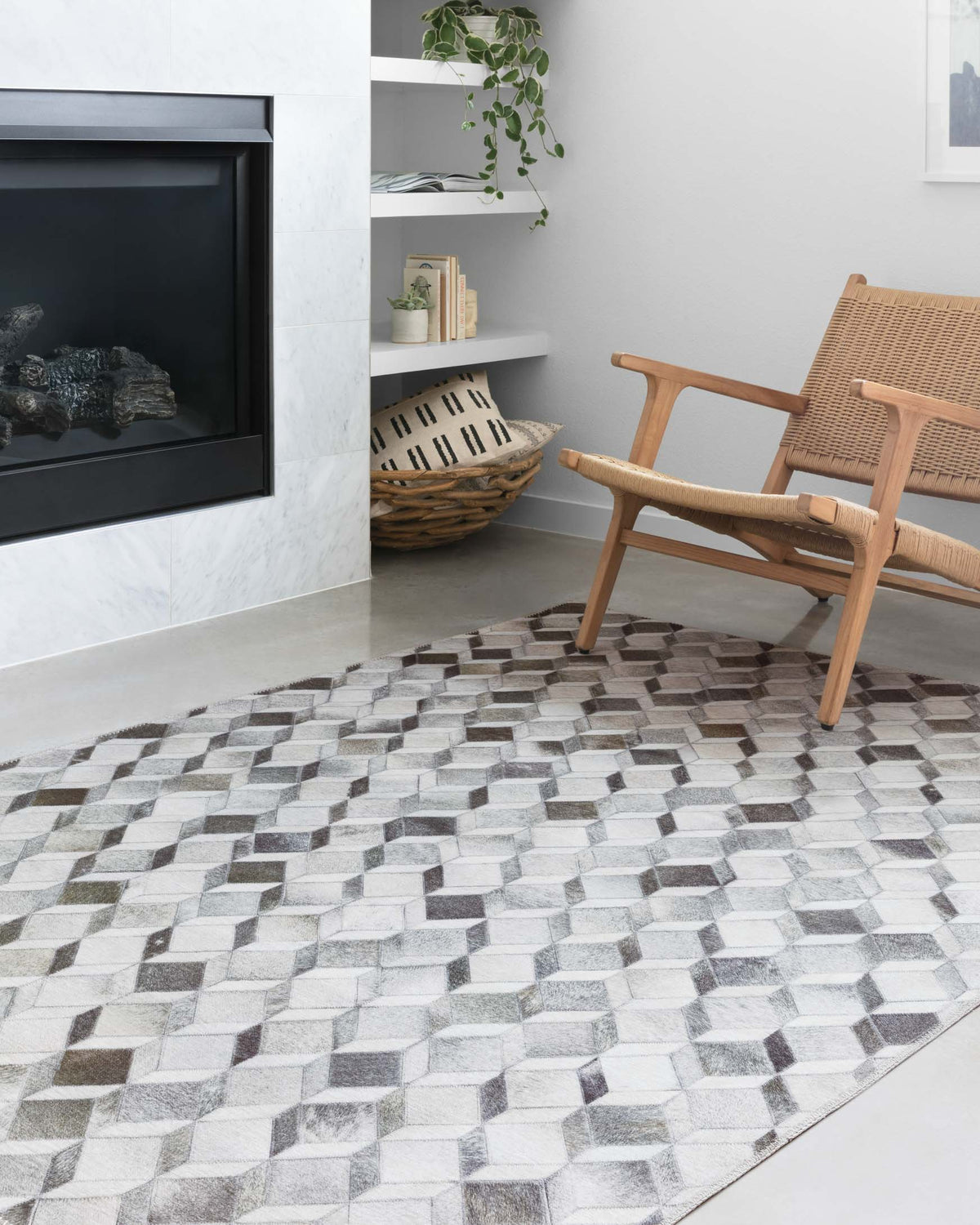 Grey geometric rug with diamond cube pattern, seen from a corner angle.