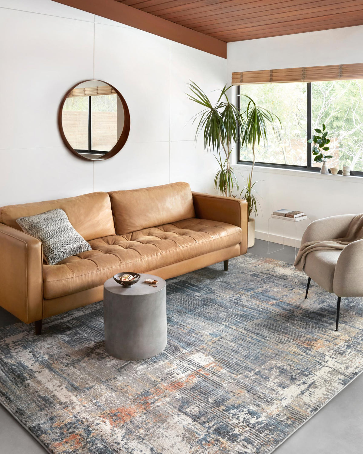 Slate blue and apricot abstract area rug, power loomed, laid on the floor