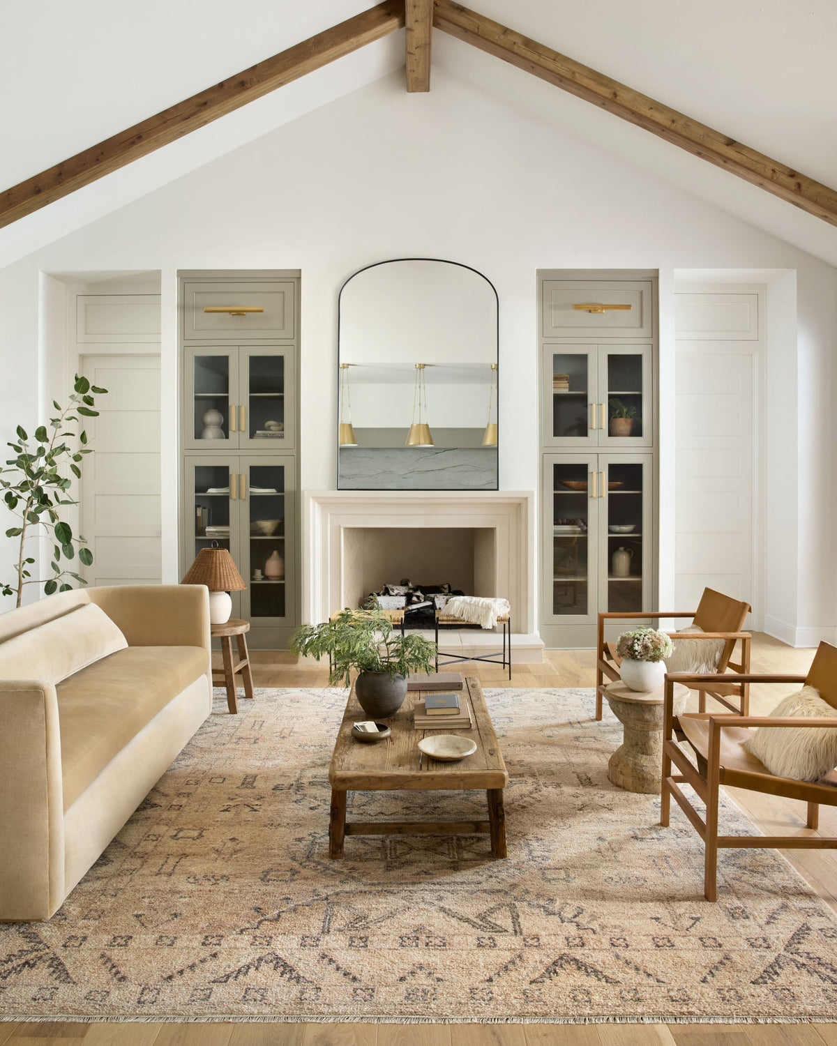 Traditional hand-woven rug with faded sand base and dark gray geometric motifs