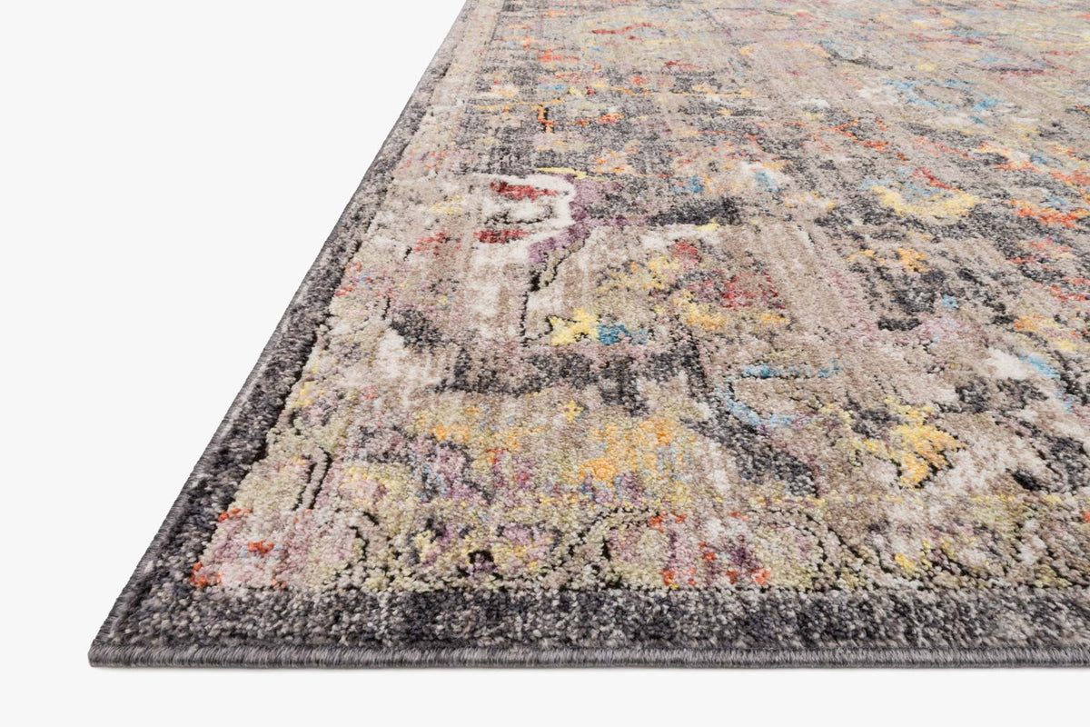 Charcoal power-loomed rug, multicolor abstract motifs and dark border, angled view