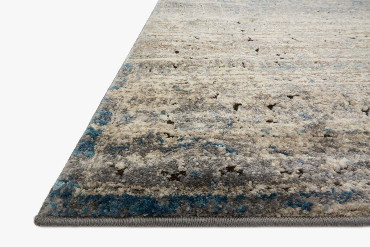 Transitional power-loomed rug corner, grey base with blue speckled abstract design