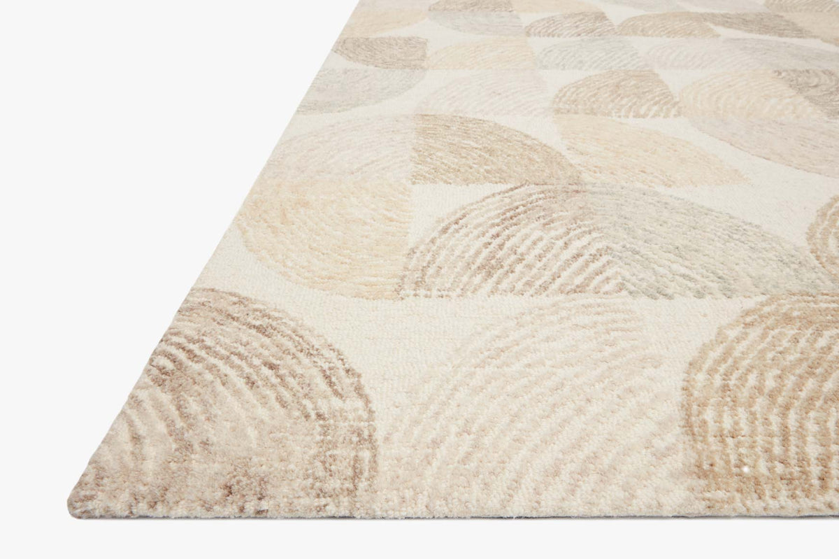Hand-tufted area rug corner with pebble circular pattern in light beige and tan