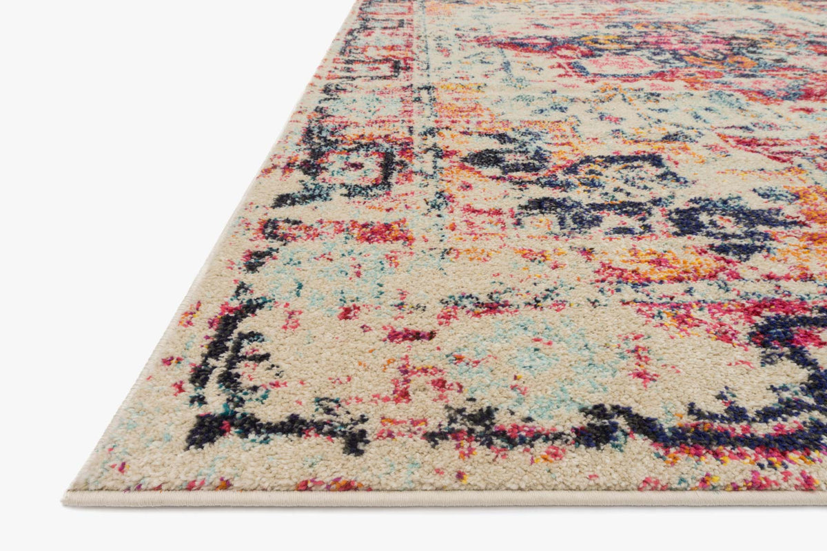 Ivory multicolor power-loomed area rug with distressed design, angled view