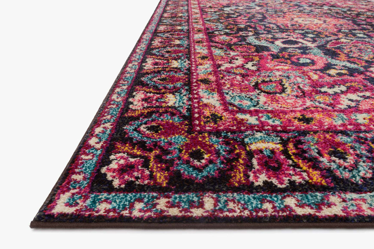 Transitional rug corner with navy, pink, teal floral motifs and multicolor border.