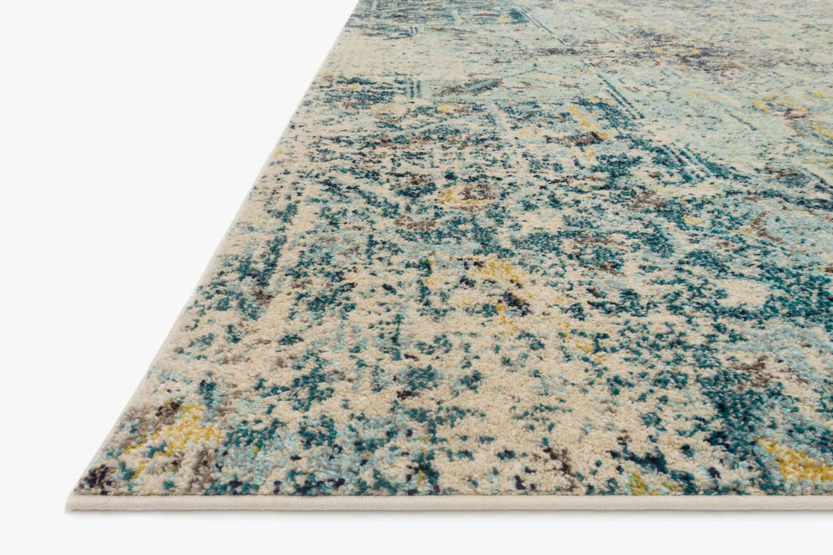 Aqua and navy rug corner view with speckled distressed abstract texture