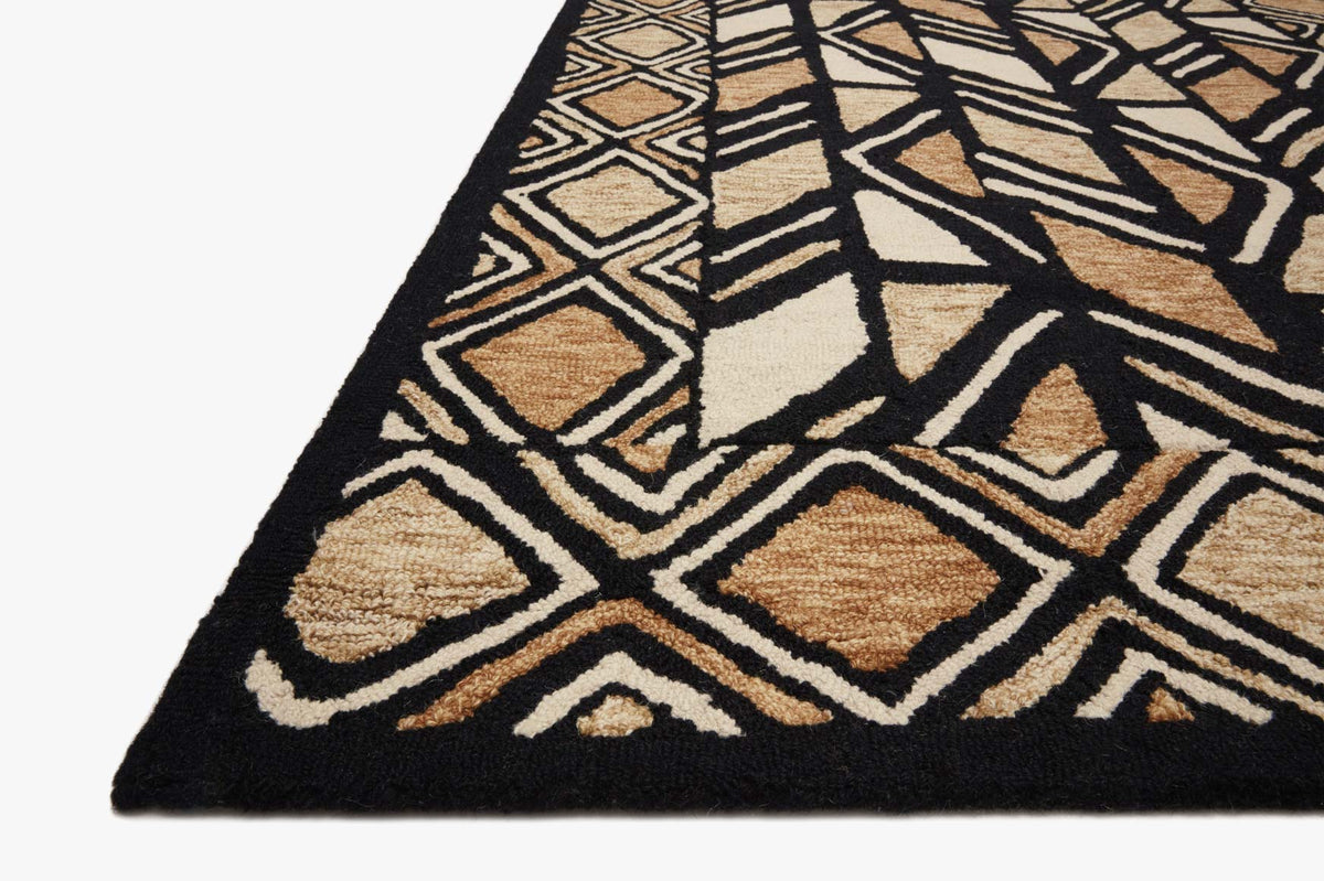 Hand-tufted rug corner in black and beige with off-white geometric zigzag pattern.