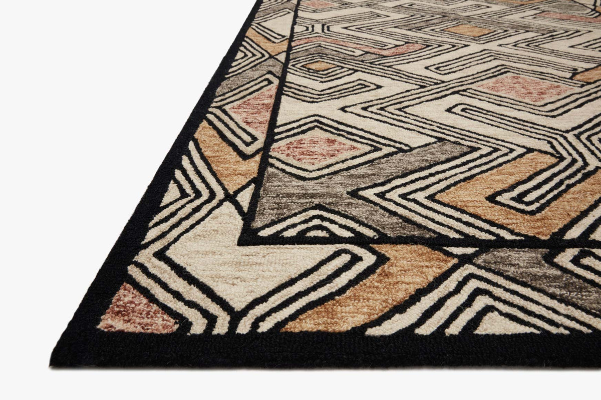 Ivory geometric rug corner with black border, zigzag lines, and rust accents