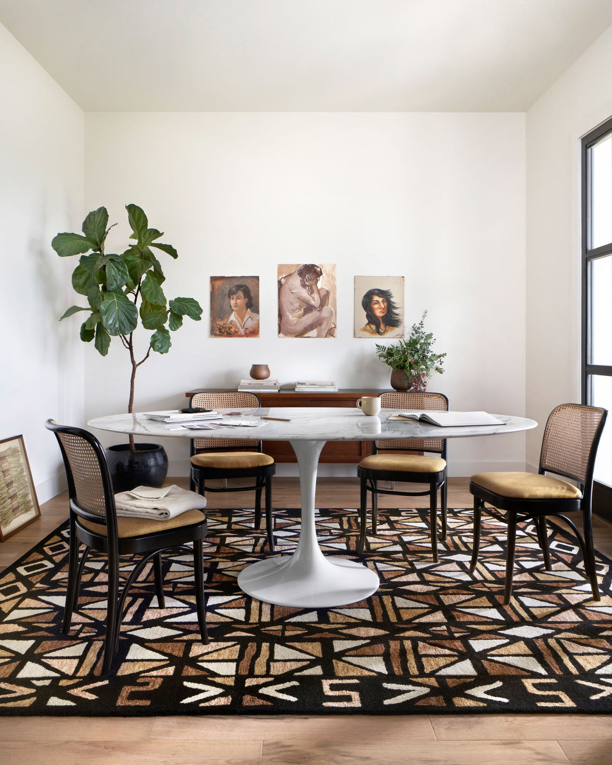 Hand-tufted area rug with bold geometric pattern in black and spice tones with cream