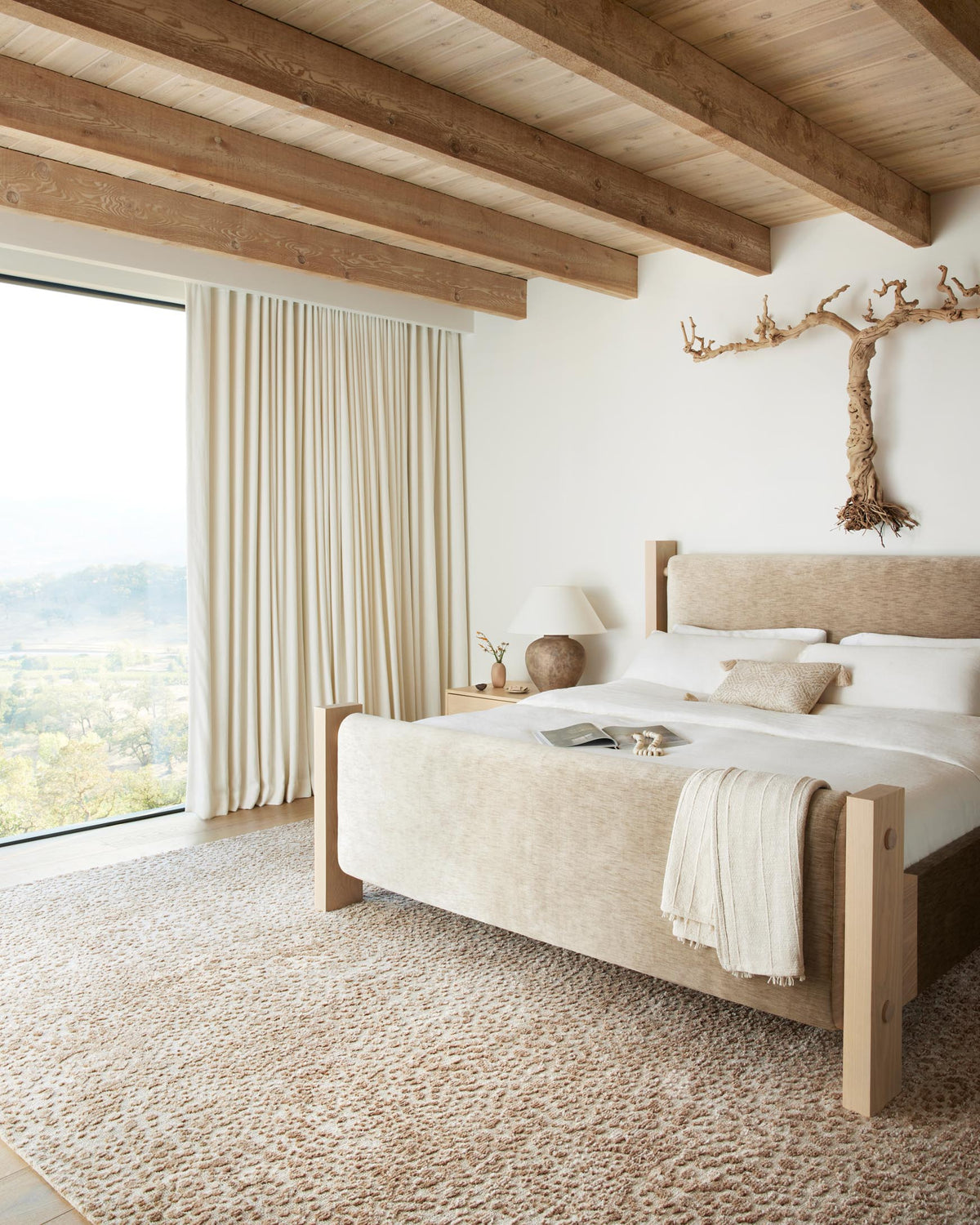 Ivory and sand power-loomed rug with mottled speckled texture, laid on floor