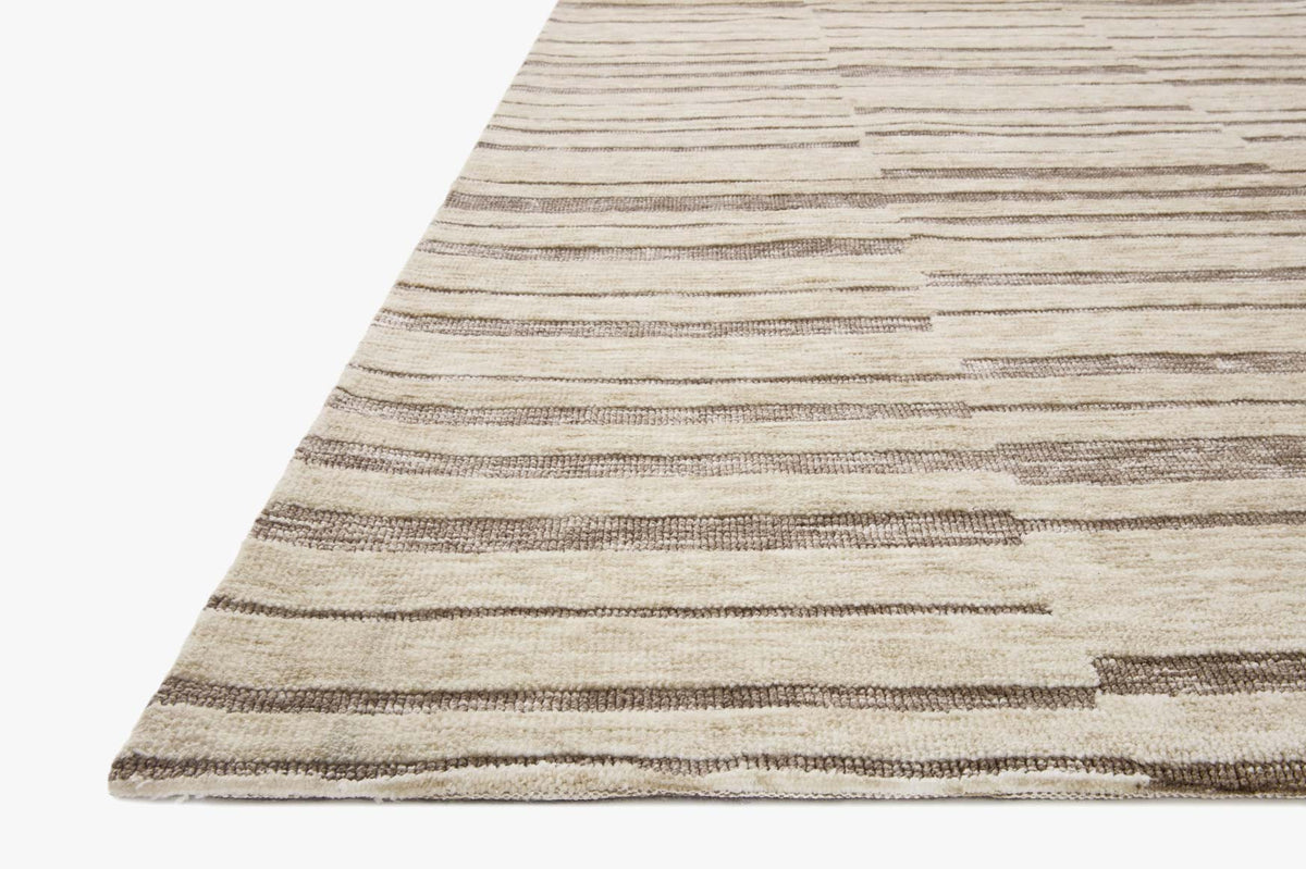 Natural and taupe rug corner showing striped block weave texture