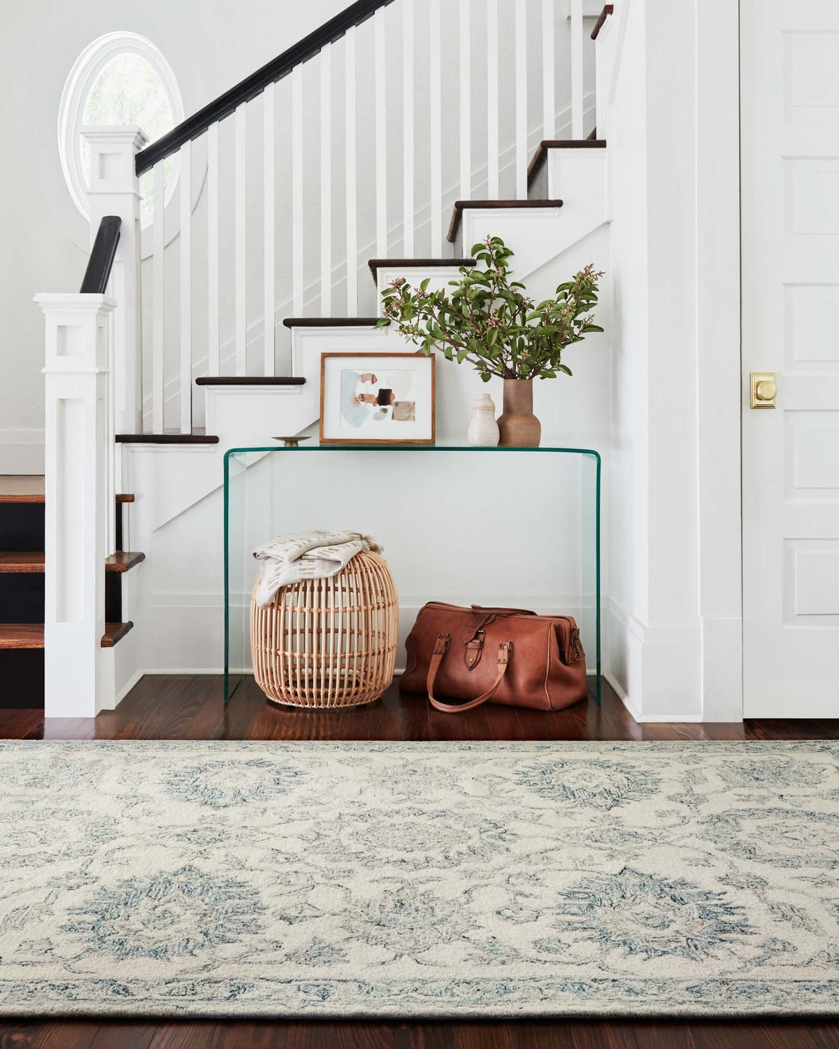 Ivory and blue hooked rug with distressed floral motif and border edge