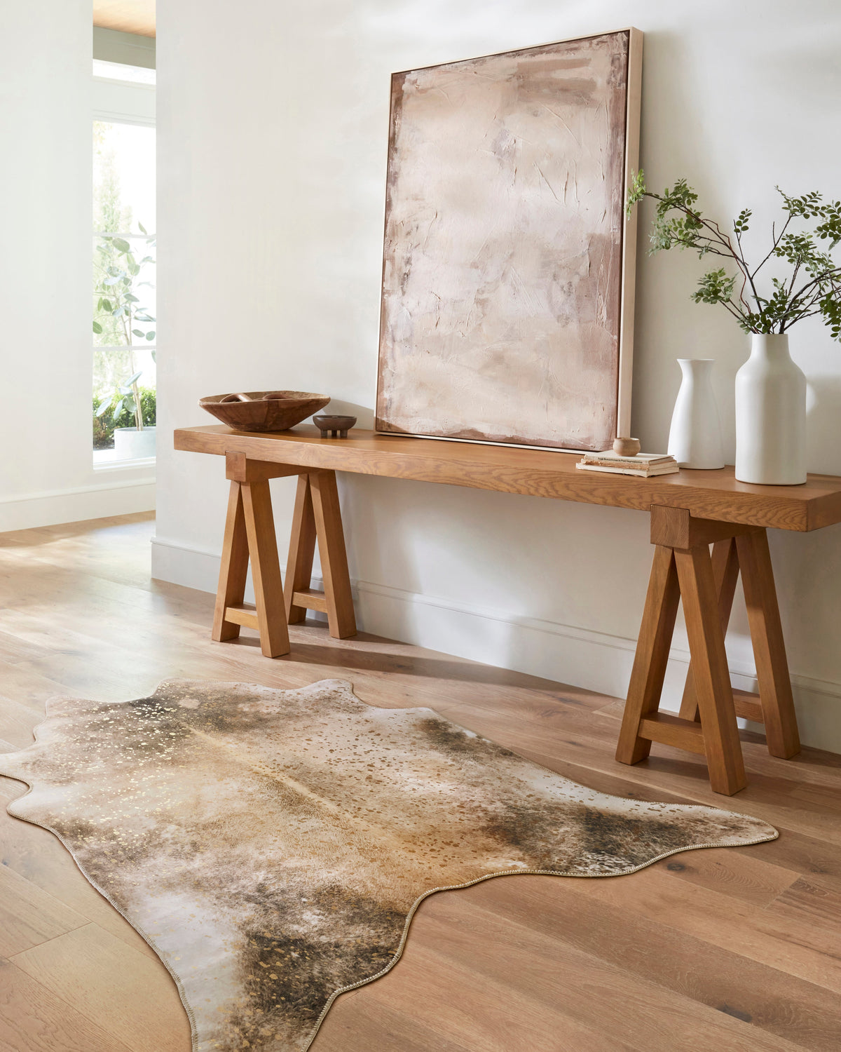 Contemporary mocha and sand area rug with speckled design, irregular hide silhouette