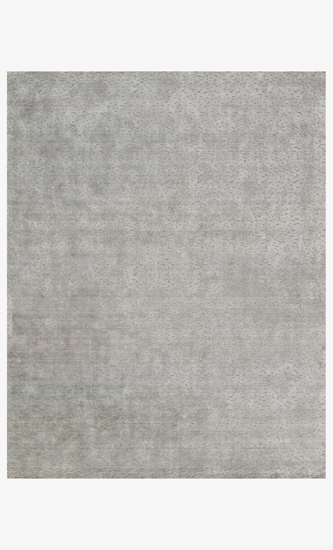 Grey hand-loomed area rug with subtle speckled texture, flat weave.