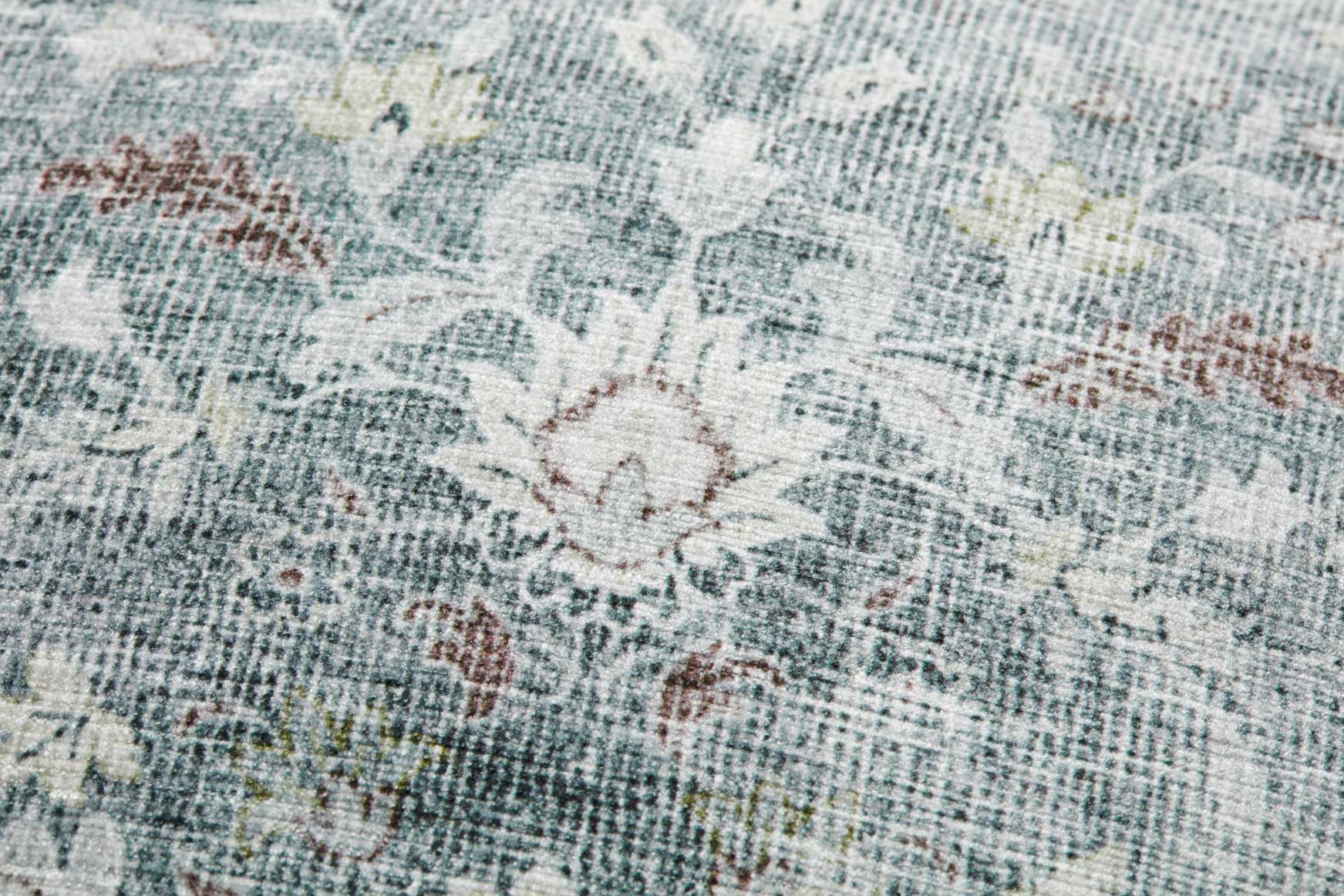 Close-up blue-gray pillow fabric with distressed floral print texture