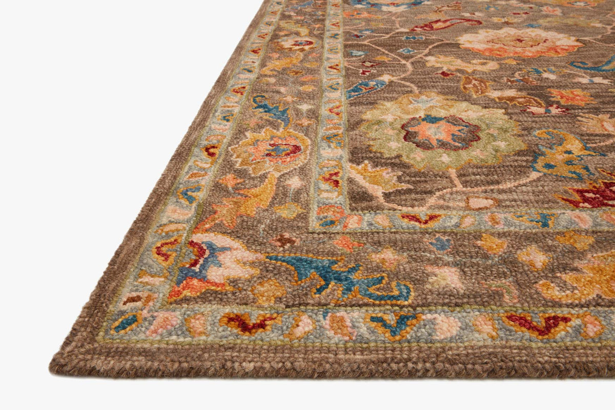Multicolor hooked rug corner in dark charcoal with patterned trim and repeating motifs