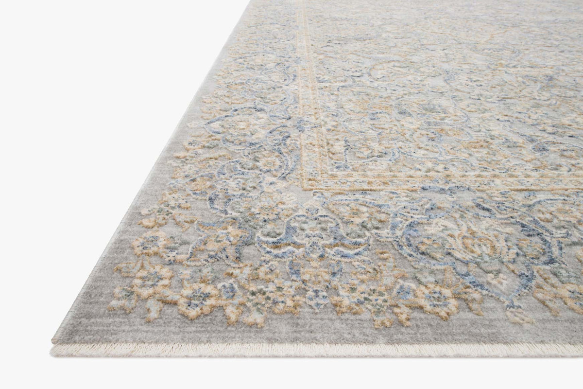 Stone and gold rug corner with ornate scrollwork design and short, flat pile edge