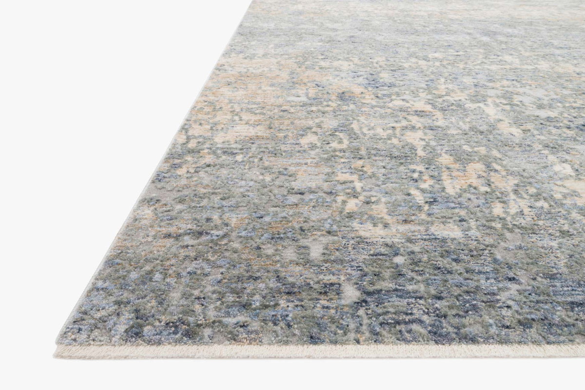 Blue and gold abstract distressed area rug, corner view with low pile