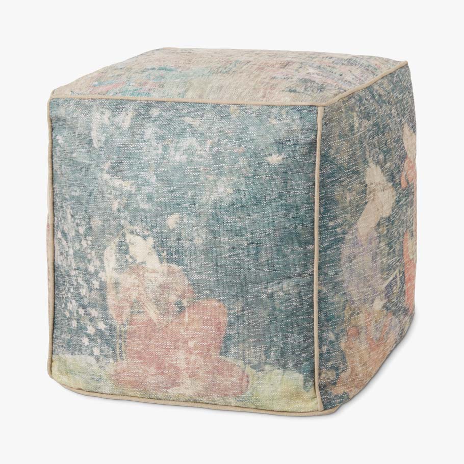 Fabric pouf ottoman with blue, beige, and pink abstract patchwork top and sides