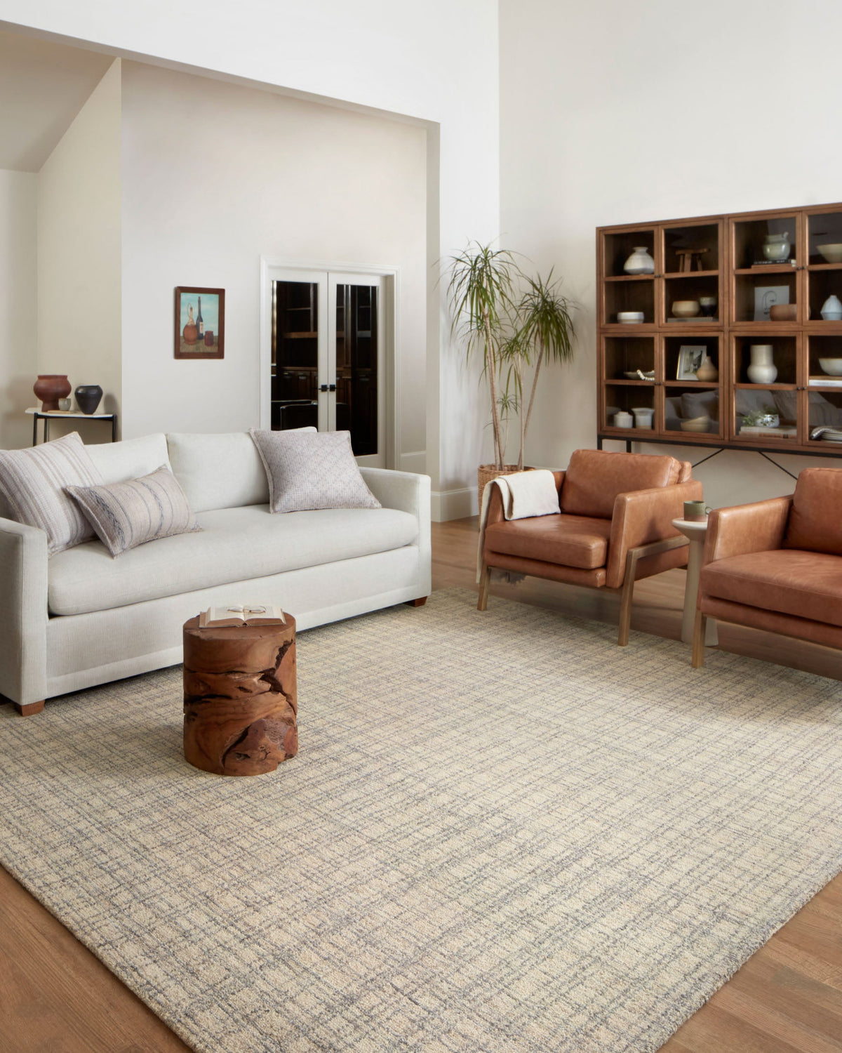Antique-and-mist area rug with light beige grid pattern and subtle pale blue accents.