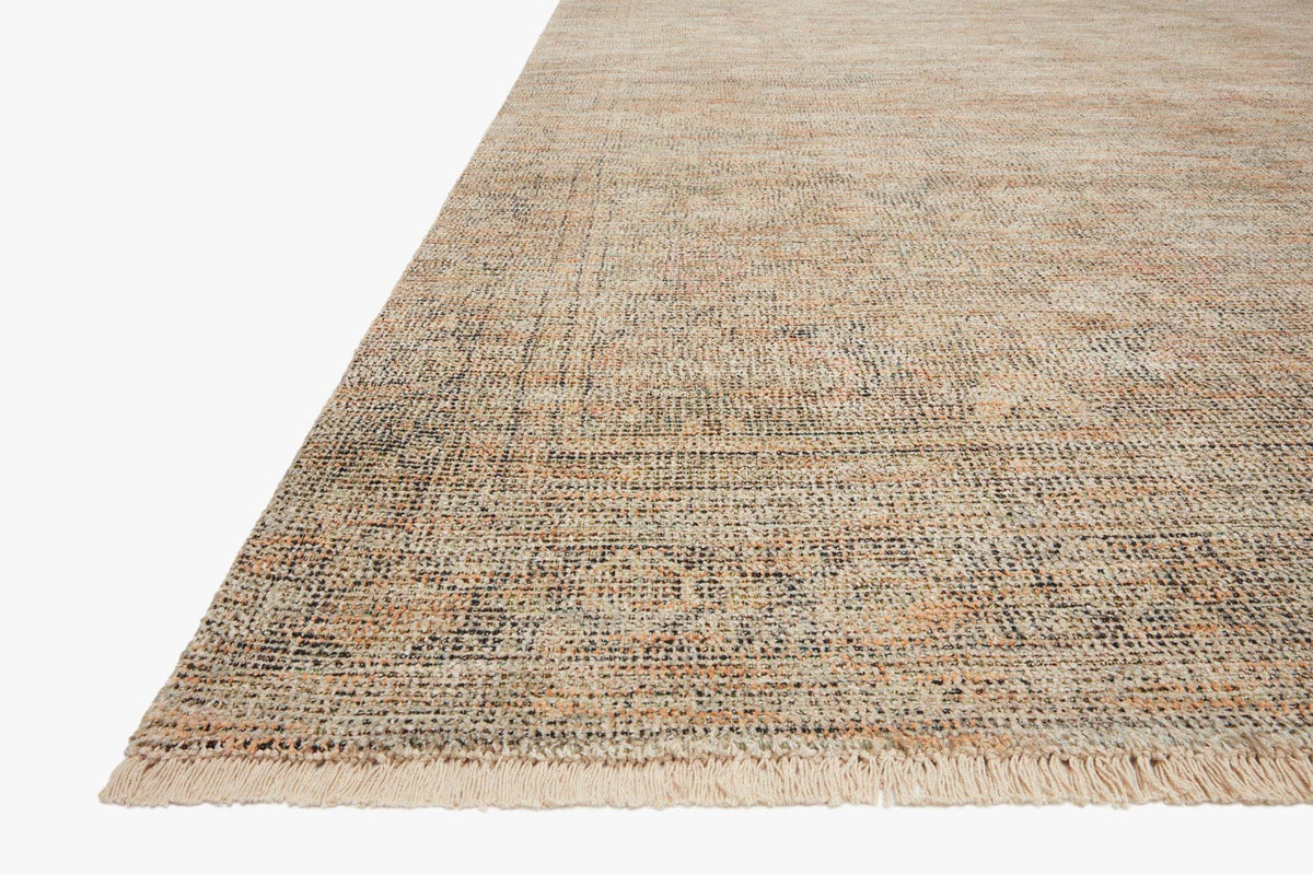 Hand-woven rug with low fringe edge; tan weave with olive and graphite flecks.