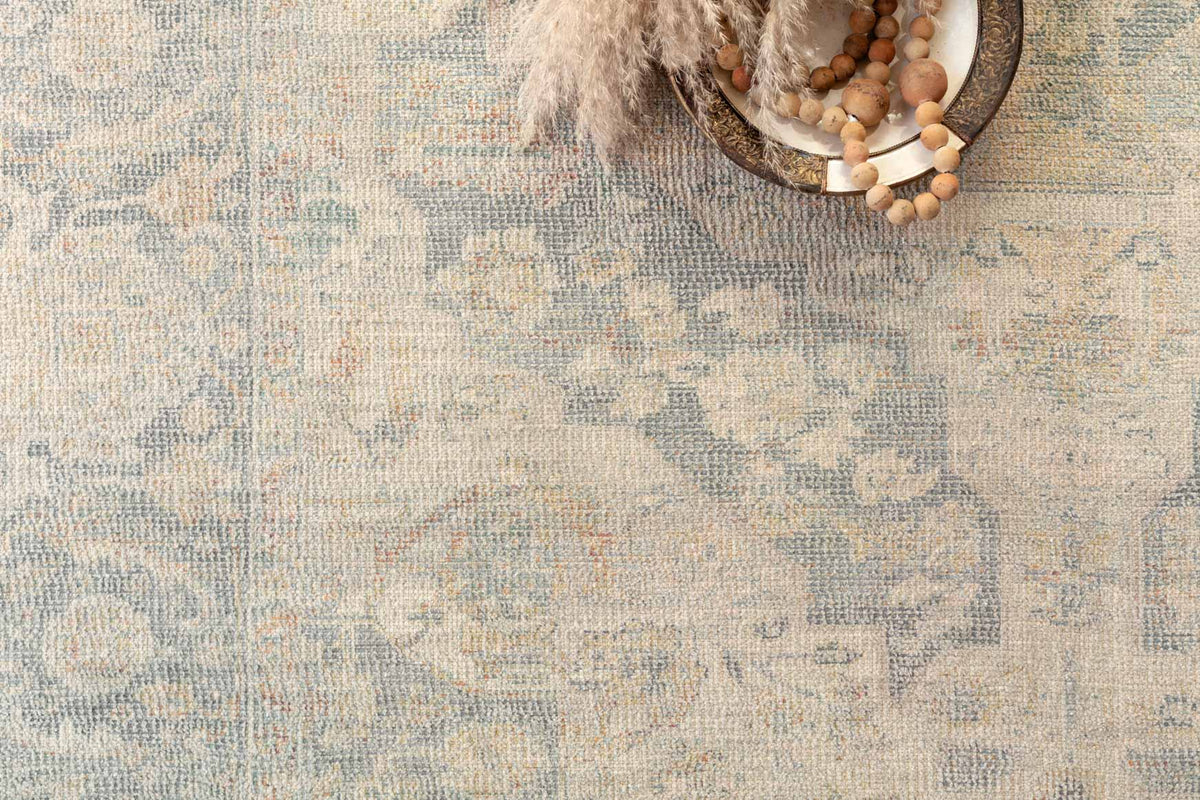 Bone and bluestone rug texture with faded distressed pattern and subtle outline details