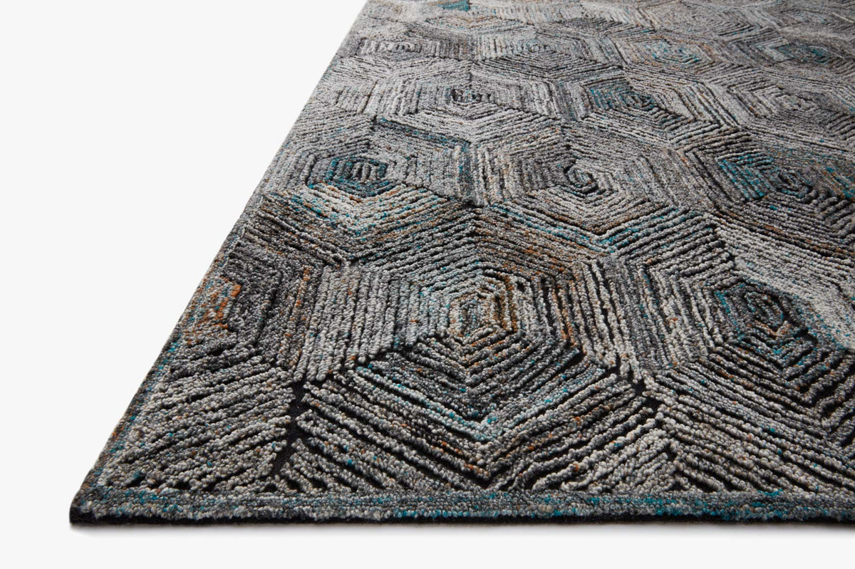 Contemporary hooked rug edge view with textured geometric lines in gray and blue.