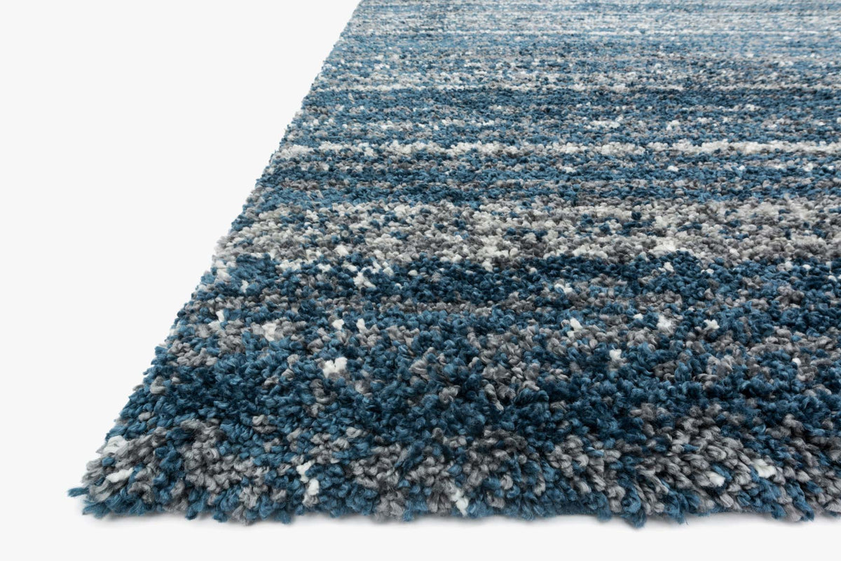 Navy and pewter shag rug corner detail with short fringe and textured fibers