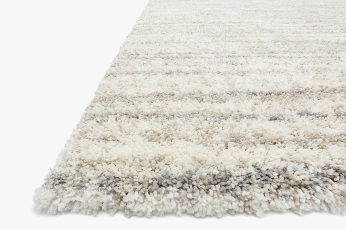 Shag rug corner close-up with thick pile and cream-to-gray tonal blend