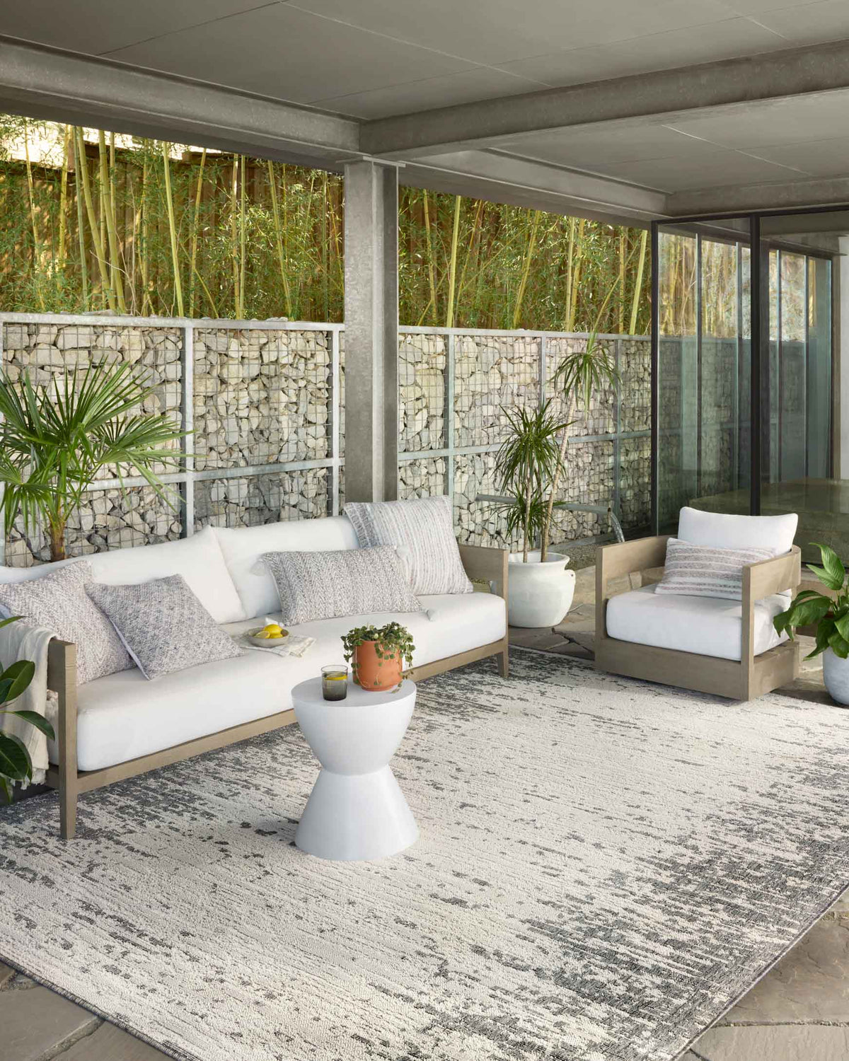 Ivory and grey power-loomed rug with abstract texture on outdoor patio floor