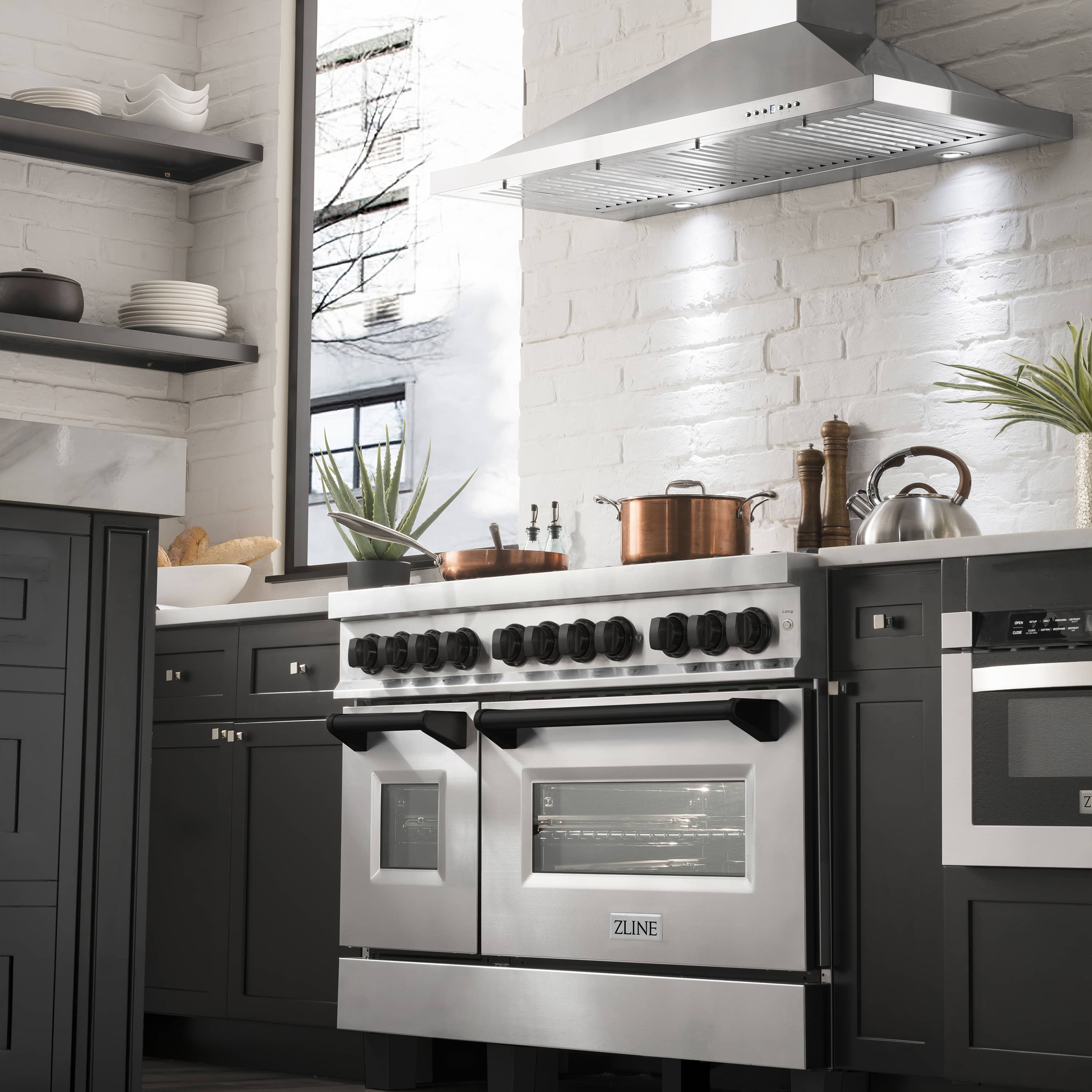 Dual fuel range oven and burner control panel with black knobs and stainless trim