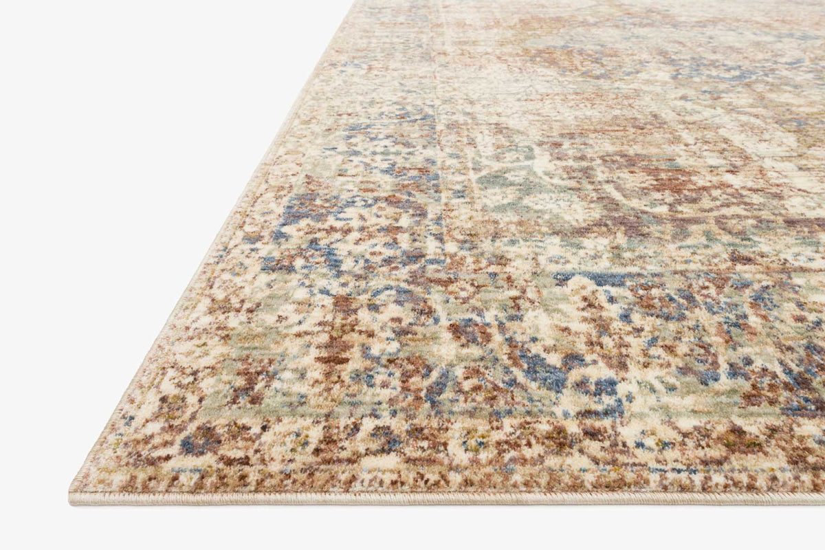 Power-loomed rug corner view with multi-color distressed pattern and border